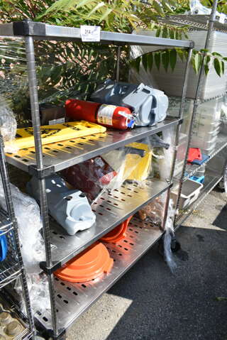 Chrome Finish 4 Tier Shelving Unit w/ Contents Including Fire Extinguisher, Wet Floor Caution Sign, Salad Spinner. BUYER MUST DISMANTLE. PCI CANNOT DISMANTLE FOR SHIPPING. PLEASE CONSIDER FREIGHT CHARGES. We Will Not Ship The Fire Extinguisher. 