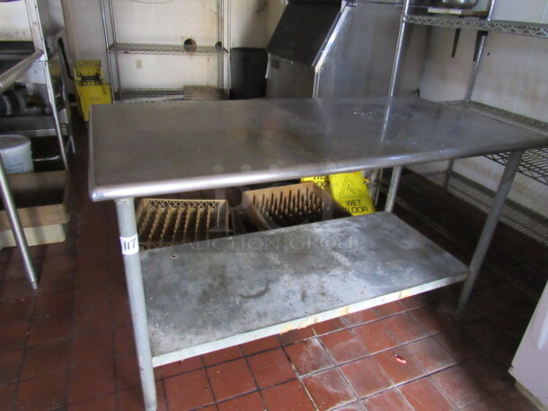 One Stainless Steel Table With Under Shelf. 60X30X35. BUYER MUST REMOVE!