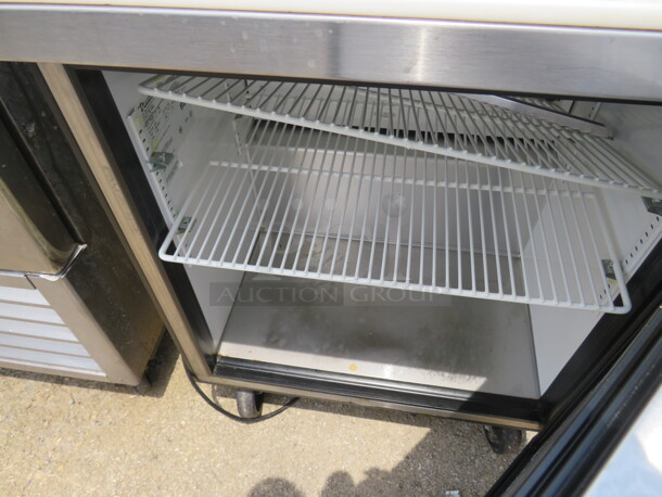 One SS True 1 Door Refrigerated Prep Table With Cutting Board, And 2 Racks On Casters. Model# TSSU-27-08. 115 Volt. 27.5X30X43. $2484.00 - Image 2 of 2