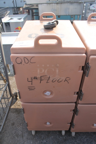 Cambro Insulated Pink Double Cavity Food Carrier With Pan Capacity And Muffin Baking Pan On Commercial Casters. 