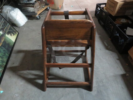 One Wooden High Chair With Safety Straps.