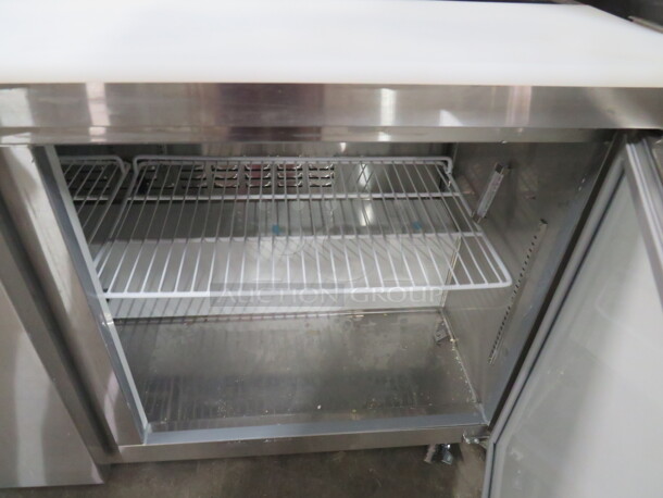 One Working Avantco 2 Door Refrigerated Prep Table With 2 Racks, And  Cutting Board On Casters. Model# 178APT60HC. 115 Volt. 60X31X43. - Image 4 of 5