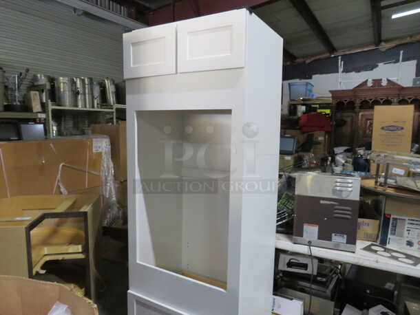 One NEW Echelon Maple Cabinet With 2 Doors, 1 Drawer And An Open Cabinet Frame For A Double Oven, In A Alpine White Finish. #OV30. 33X25X84