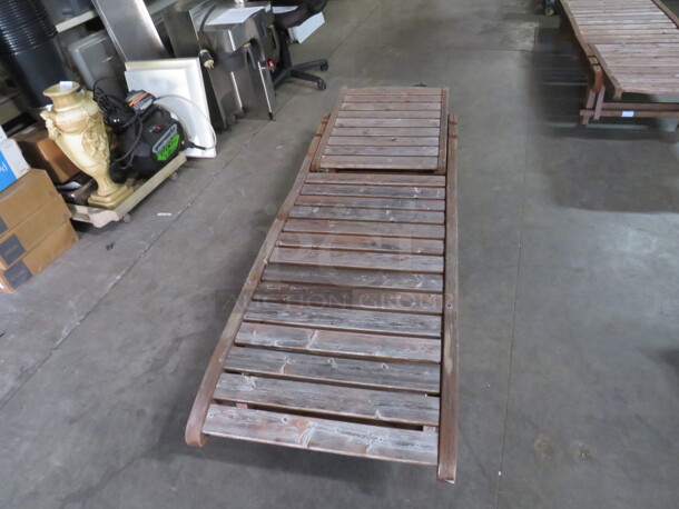 One Adjustable Wooden Chaise Lounger With 2 Wheels, And A Pullout Shelf. Needs A Lil Adjusting. No SH
helf 72X23 - Image 1 of 2