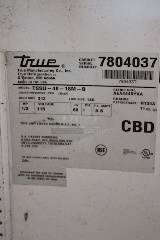 OUTSTANDING! True TSSU-48-18M-B Mega-Top Solid Door Sandwich/Salad Unit On Commercial Casters. 115v/60hz/1ph/15amps. TESTED! Turns On, Blows COLD Air. Unit Was Plugged In A Running While Photographing. 48-3/8x34-1/8x40-3/8 Normal wear and tear, minor cosmetic crack in lid, Dust From Storage.	 - Image 4 of 7