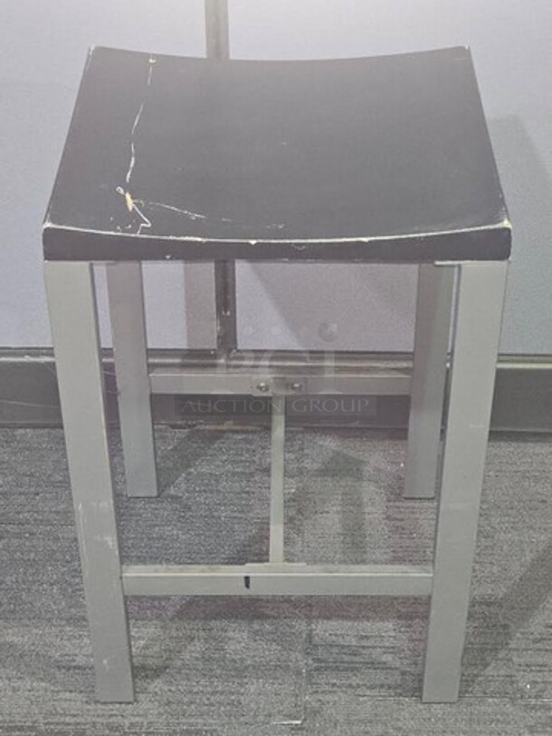 Stools. Silver finish metal framing with wooden black seat. Has wear and scratches on the seat as well as some on the frame but in good condition! Measures 24.5” H x 15.5” W x 14” D. BIDX8

 - Image 2 of 2