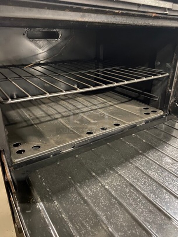 AMAZING FIND! Garland Natural Gas Powered 12 Burner Stove! With 2 Full-Sized Ovens! With Metal Oven Racks! With Raised Back Splash & Salamander Shelf! Stainless Steel! On Casters! - Image 7 of 9