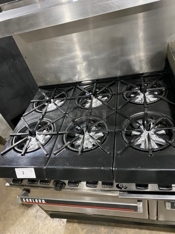 GREAT FIND! Garland Commercial Gas Powered 6 Burner Stove With Right Side Flat Griddle! Griddle Has Side Splashes! With Raised Back Splash And Salamander Shelf! With 2 Oven Underneath! Metal Oven Racks! All Stainless Steel! On Casters! Working When Removed! - Image 6 of 12