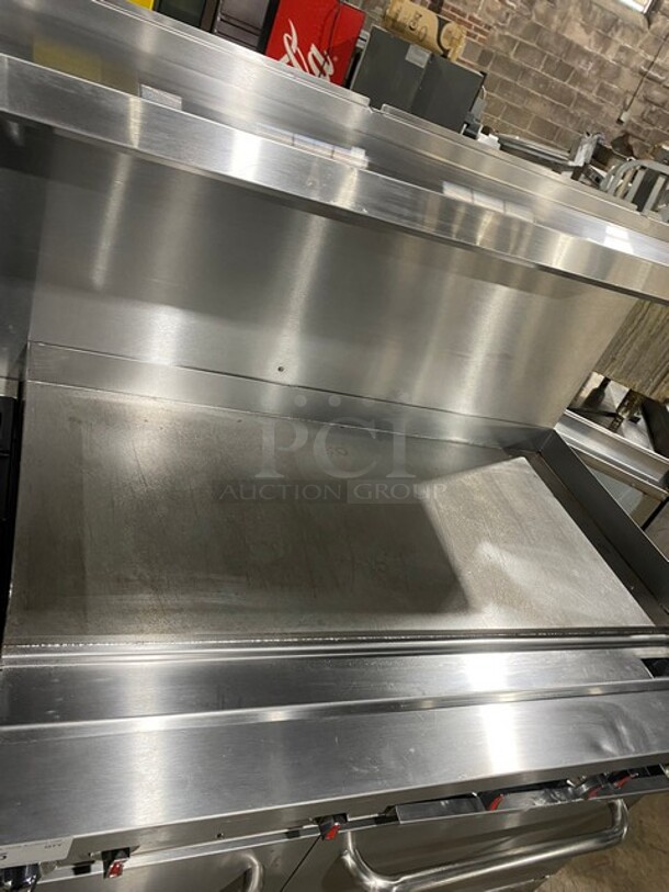 CPG Commercial LP Powered Flat Top Griddle Stove With Left Side 2 Burner! Griddle Has Side Splashes! With Raised Back Splash And Salamander Shelf! With 2 Oven Underneath! Metal Oven Racks! All Stainless Steel! On Casters! Working When Removed! Model: S60G48L SN: 09227429 - Image 7 of 12