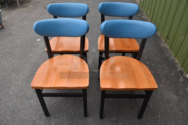 4 Chairs With Black Frame, Wood Style Seat And Blue Cushioned Stretcher. 4 Times Your Bid! Cosmetic Condition May Vary.