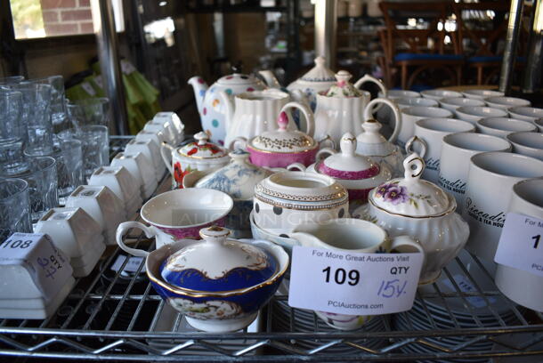 15 Various White Ceramic Items; Sugar Holder, Pitcher, Mugs and Tea Pot. Includes 10.5x5.5x7. 15 Times Your Bid!