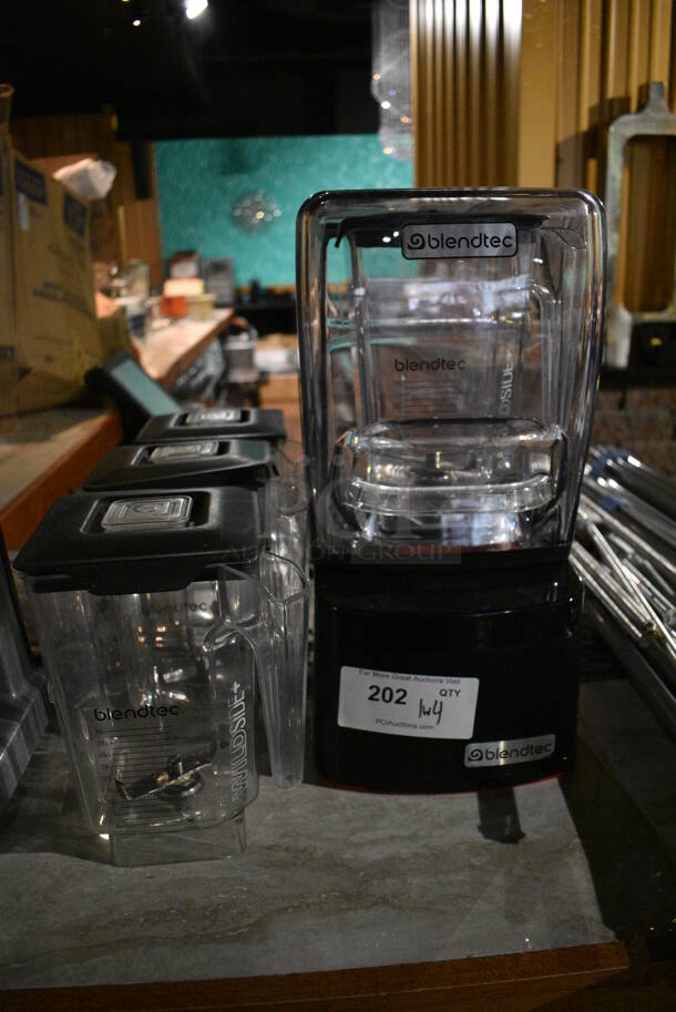 Blendtec CQB1 Metal Commercial Countertop Blender w/ Dome Cover and 4 Pitchers. 110-120 Volts, 1 Phase. 8.5x8.5x17. Item Was in Working Condition on Last Day of Business. (bar)