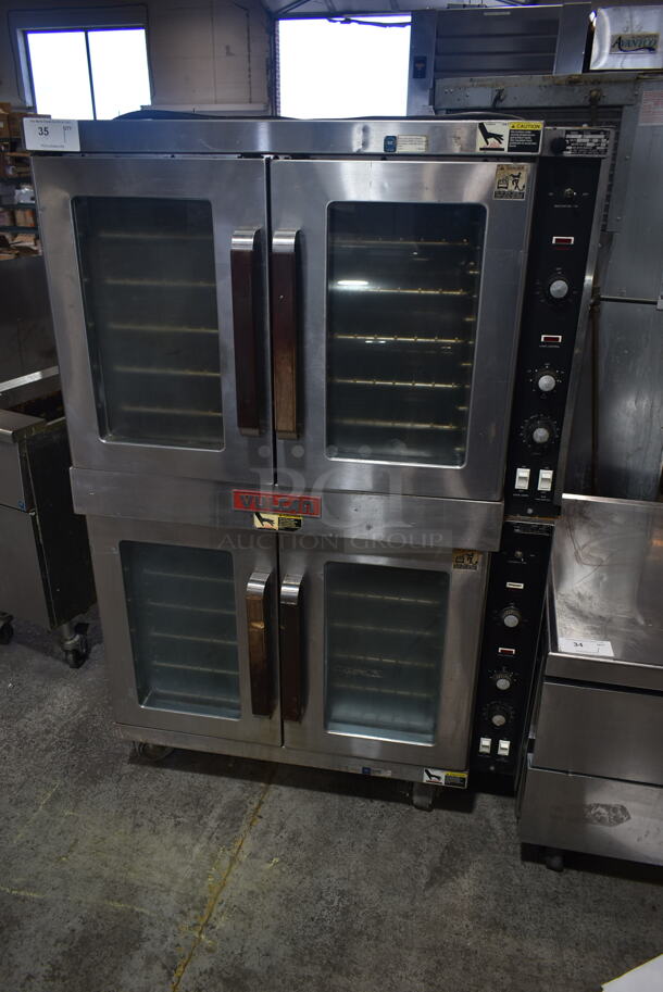 2 Vulcan ET88T Stainless Steel Commercial Electric Powered Full Size Convection Oven w/ View Through Doors, Metal Oven Racks and Thermostatic Controls on Commercial Casters. 480 Volts, 3 Phase. 2 Times Your Bid!