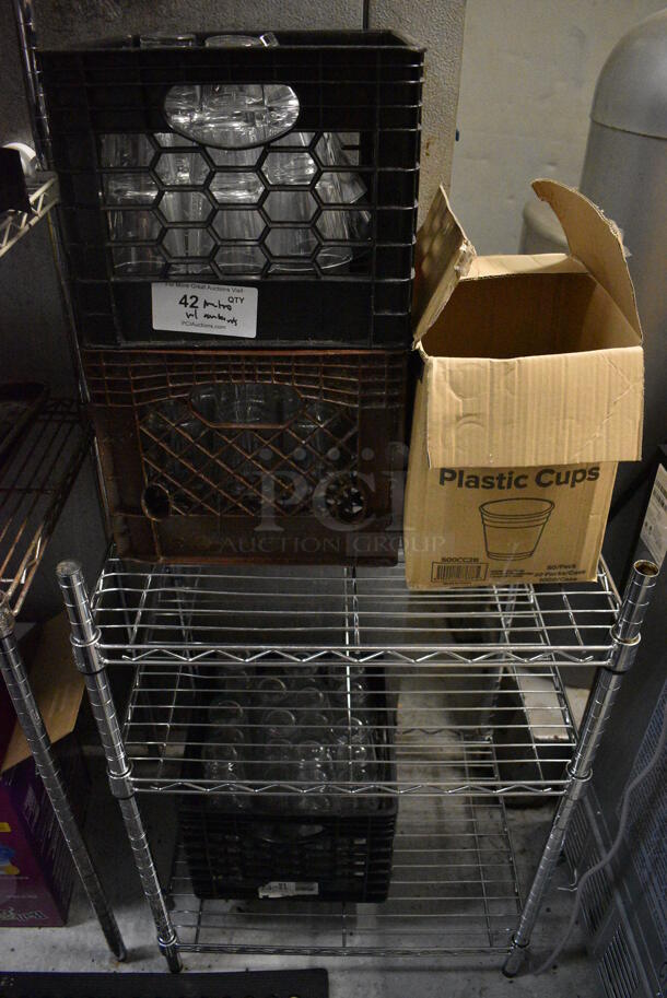 Chrome Finish 3 Tier Shelving Unit w/ Contents Including Beverage Glasses. 24x18x36. BUYER MUST REMOVE. BUYER MUST DISMANTLE. PCI CANNOT DISMANTLE FOR SHIPPING. PLEASE CONSIDER FREIGHT CHARGES. (kitchen)