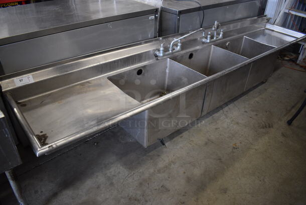 Stainless Steel Commercial 3 Bay Sink w/ Dual Drainboards, 2 Faucets and 2 Handle Sets. Does Not Have Legs. 124x25x25.5. Bays 24x18x14. Drainboard 24x21x2