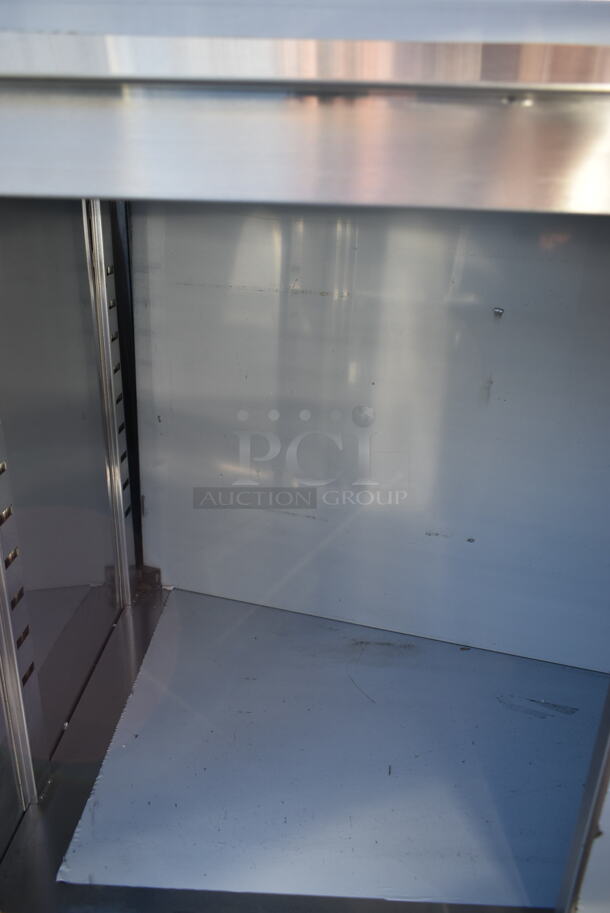 BRAND NEW SCRATCH AND DENT! Regency 600EBTB3072R 30" x 72" 16 Gauge Type 304 Stainless Steel Enclosed Base Sliding Door Table with Drawers and 6" Backsplash - Image 7 of 9
