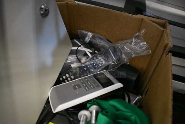 ALL ONE MONEY! Lot of Various Items Including a Security Tronix Box, Remote Controls and Green T-Shirt. - Image 4 of 4