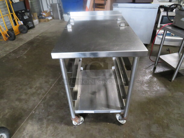 One Stainless Steel Table With Under Racks, On Casters. 24X35X37.5