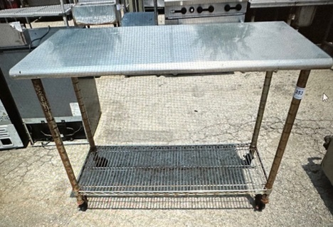 One Stainless Steel Table With A Metro Under Shelf On Casters. 49.5X24X39