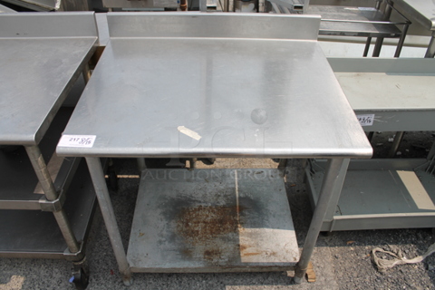 Stainless Steel Commercial Table w/ Back Splash and 2 Under Shelf.