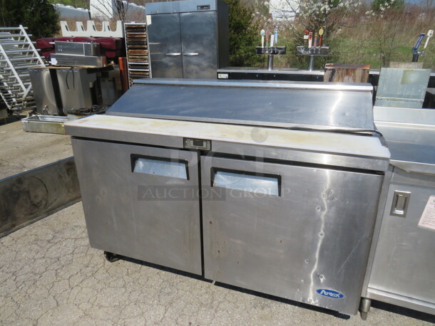 One Atosa 2 Door Refrigerated Prep Table With Cutting Board, 2 Racks, On Casters. Model# MSF8303. 115 Volt. 60.5X31X45