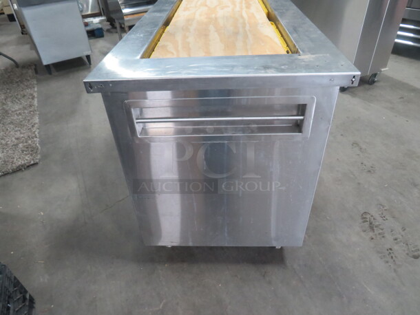 One Delfield Stainless Steel Serving Table With A 50X20X6 Well, And 2 Stainless Under Shelves, On Casters. 63X30X36  - Image 5 of 5