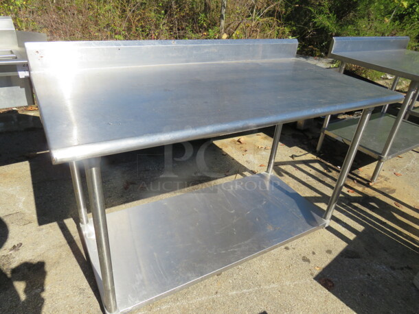 One Stainless Steel Table With Back Splash And SS Under Shelf. 60X30X40.5 - Image 1 of 1