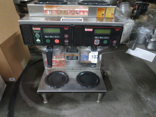 One Bunn Dual Digital Coffee Brewer With Dual Warmers, And 2 Filter Baskets. Model# AXIOM 2/2 Twin WCRD/DD. 120-208/240 Volt. 7500 Watt.  - Image 1 of 3