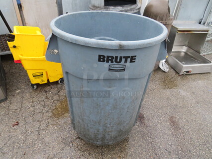 One Rubbermaid Brute Trash Can On A Dolly.