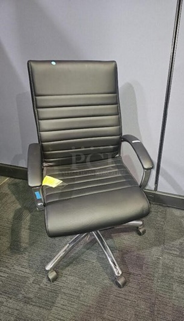 Item #60- Silver metal framed rolling office chair. Cushioned and ribbed black leather upholstery with armrests. A nice used piece! Measures 43” H x 22” W. 

 - Image 2 of 3