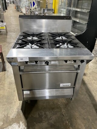 Garland Commercial Natural Gas Powered 4 Burner Stove! With Back Splash! With Oven Underneath! Metal Oven Rack! All Stainless Steel! On Casters! Model: M44R SN: 1601100100589