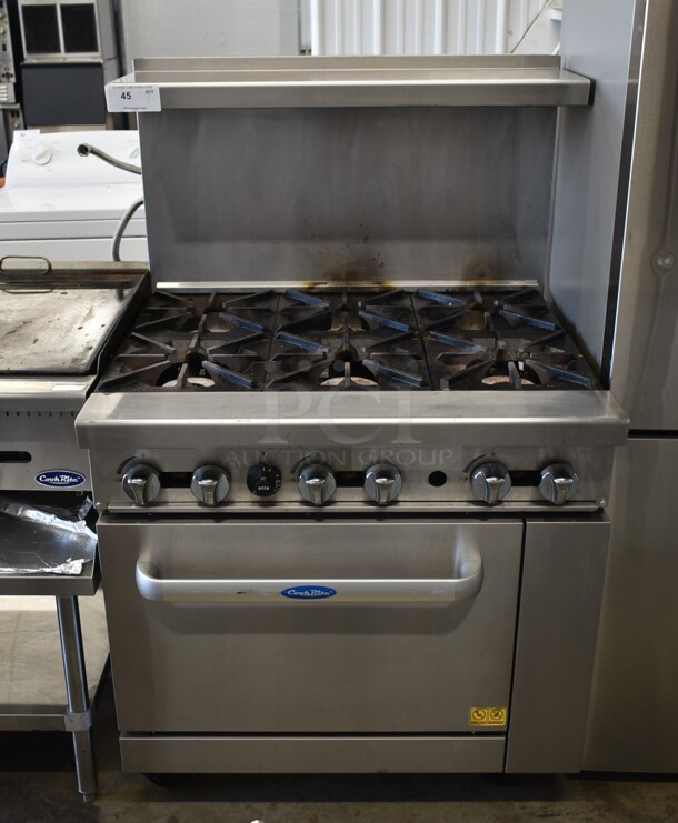 Cook Rite Stainless Steel Commercial Propane Gas Powered 6 Burner Range w/ Oven, Over Shelf and Back Splash on Commercial Casters.  - Image 1 of 7