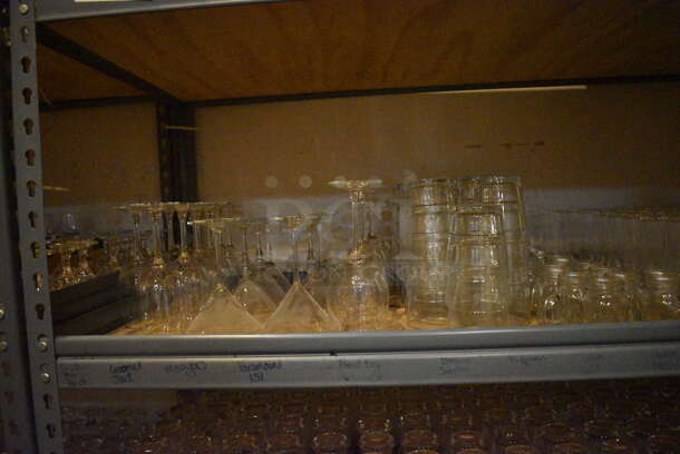 Gray Metal 5 Tier Shelving Unit w/ Contents Including Beverage Glasses and Wine Glasses. 48x24x72. BUYER MUST REMOVE; BUYER MUST DISMANTLE. PCI CANNOT DISMANTLE FOR SHIPPING. PLEASE CONSIDER FREIGHT CHARGES. (glass room - off of bar area) - Image 3 of 10