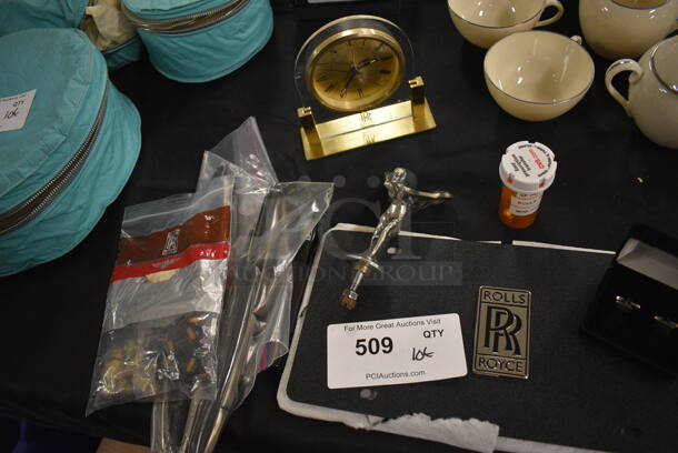 ALL ONE MONEY! Lot of Rolls Royce Items Including Clock, License Plate Cover, Cuff Links, Windshield Wiper Blades, Spirit of Ecstasy Emblem, Flash Light, Aprons, Car Parts and Mini Fuses - Image 1 of 12