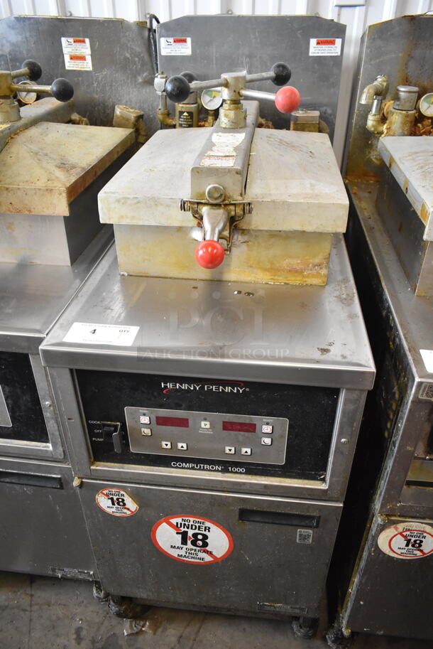 Henny Penny 600 Stainless Steel Commercial Floor Style Natural Gas Powered Pressure Fryer on Commercial Casters. 80,000 BTU.