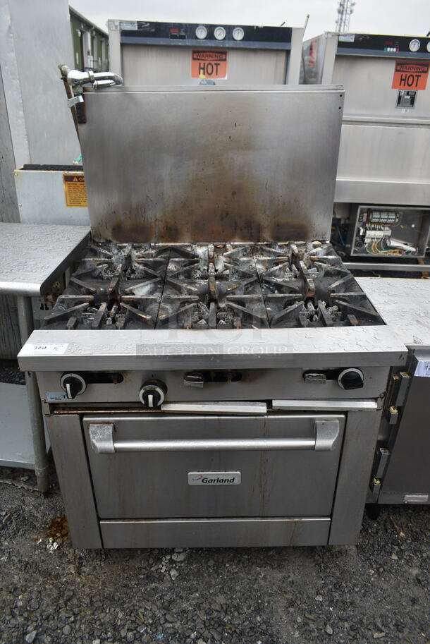 Garland G36-6R Stainless Steel Commercial Natural Gas Powered 6 Burner Range w/ Oven and Back Splash.  - Image 1 of 8