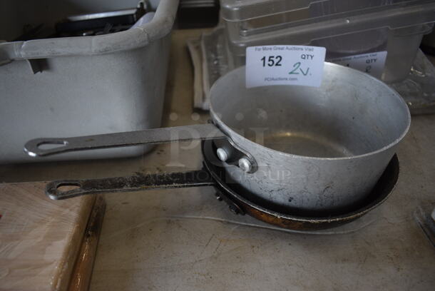 2 Metal Items; Sauce Pans and Skillet. 14x8x4, 14x8.5x2. 2 Times Your Bid!