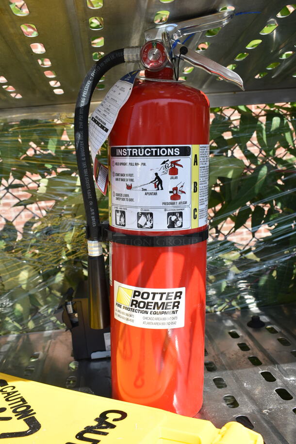 Chrome Finish 4 Tier Shelving Unit w/ Contents Including Fire Extinguisher, Wet Floor Caution Sign, Salad Spinner. BUYER MUST DISMANTLE. PCI CANNOT DISMANTLE FOR SHIPPING. PLEASE CONSIDER FREIGHT CHARGES. We Will Not Ship The Fire Extinguisher.  - Image 7 of 12