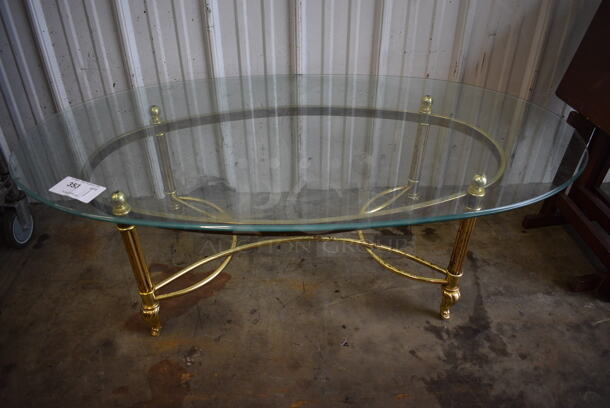 Gold Colored Metal Coffee Table w/ Glass Oval Tabletop. 50x26x16 - Image 1 of 3