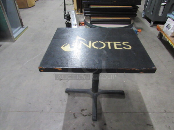 One 2 Inch Thick Solid Wood Table Top Painted Black, With The NOTES Logo  On A Pedestal Base. 30X24X30