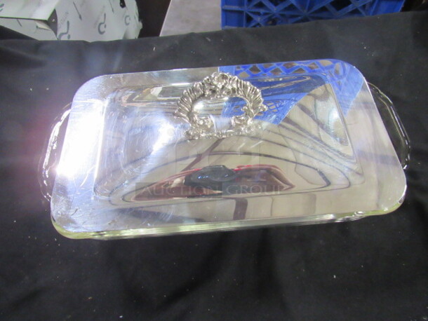 One Clear Glass Baking Dish With Silver Lid.