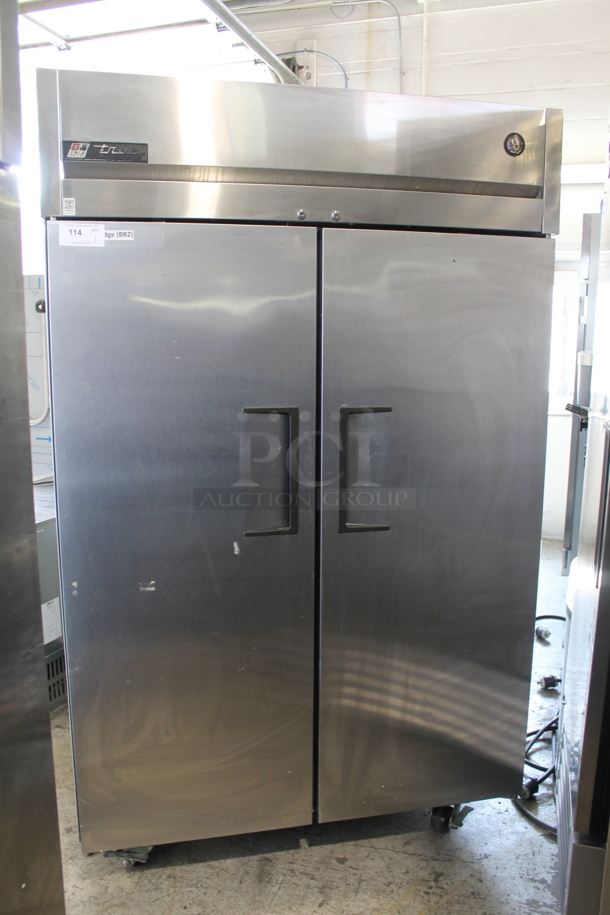 2015 True TG2R-2S Stainless Steel Commercial 2 Door Reach In Cooler w/ Poly Coated Racks on Commercial Casters. - Item #1058716
