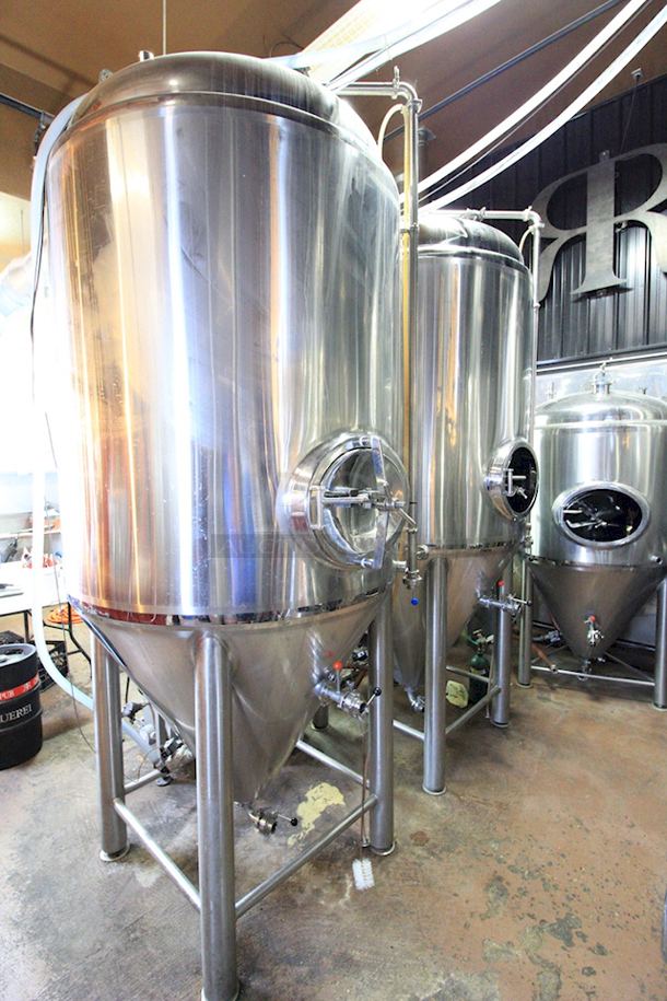 ? ? BEAUTIFUL!! Stout Tanks & Kettles - 15 BBL Fermenter / Unitank (Jacketed). ? ? Features: Easily Converts to a Unitank or Brite Serving Tank; Glycol Jacketed - 2 Zones: Cone and Sidewall; Shadowless Manway for Easy Cleaning; Adjustable Racking Arm for Clear Transfer; 1.5" Sample Valve for Quality Testing; Back Mounted Pressure Gauge; Adjustable Feet for Leveling on Uneven Floors or Fine Height Adjustments; Pressure Gauge Type: Back Mount; CIP Arm and 2.5" Rotating CIP Spray Ball; 2 Butterfly Valves; Rated to 2-Bar (29 PSI); 1/2" NPT Welded Thermowell for Contactless Temperature Probe Tank Thickness: 3mm Jacket and Outer Shell Thickness: 2mm. Cone: 60 degree Interior Angle. 51.5-in. diameter x 125-in.H. - Image 6 of 8