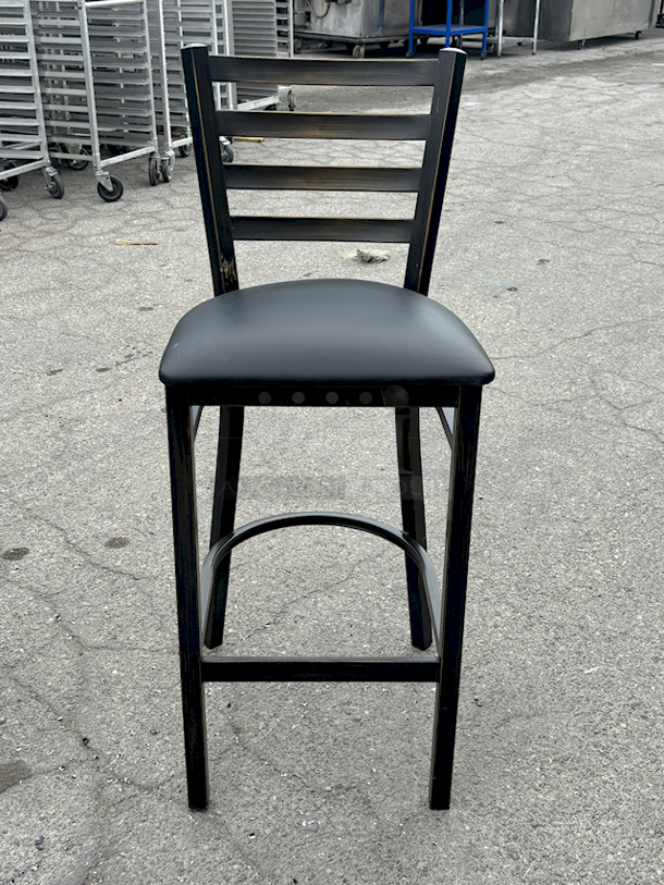 BRAND NEW SCRATCH & DENT! Lancaster Table & Seating (10) Black Finish Cross Back & (1) Distressed Copper Finish Ladder Back Bar Stools with 2 1/2" Navy Vinyl Padded Seat. 11x Your Bid  - Image 9 of 12