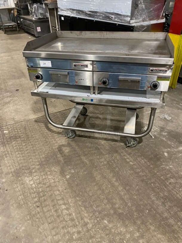WOW! NEW OUT OF THE BOX! Garland Commercial Countertop Electric Powered Flat Top Griddle! With Back And Side Splashes! On Legs! On Equipment Stand! All Stainless Steel! On Casters! Model: E2448G SN: 0404ME0033 208V 60HZ 3 Phase