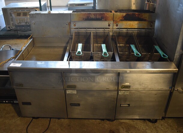 Pitco Frialator Model SG18 Stainless Steel Commercial Natural Gas Powered 2 Bay Deep Fat Fryer w/ Left Side Model SGBN Dumping Station and 4 Metal Fry Baskets on Commercial Casters. 140,000 BTU. 59x34.5x45.5