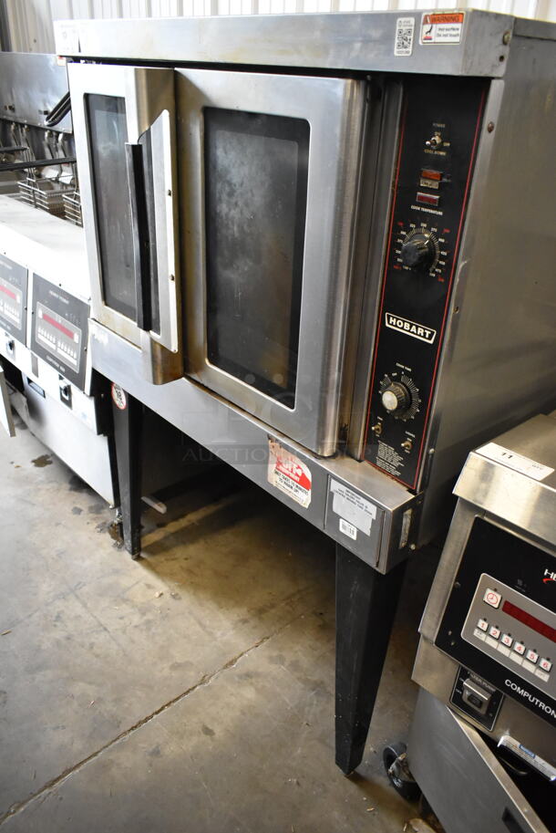 Hobart HGC5 Stainless Steel Commercial Propane Gas Powered Full Size Convection Oven w/ View Through Doors, Metal Oven Racks and Thermostatic Controls on Metal Legs. 