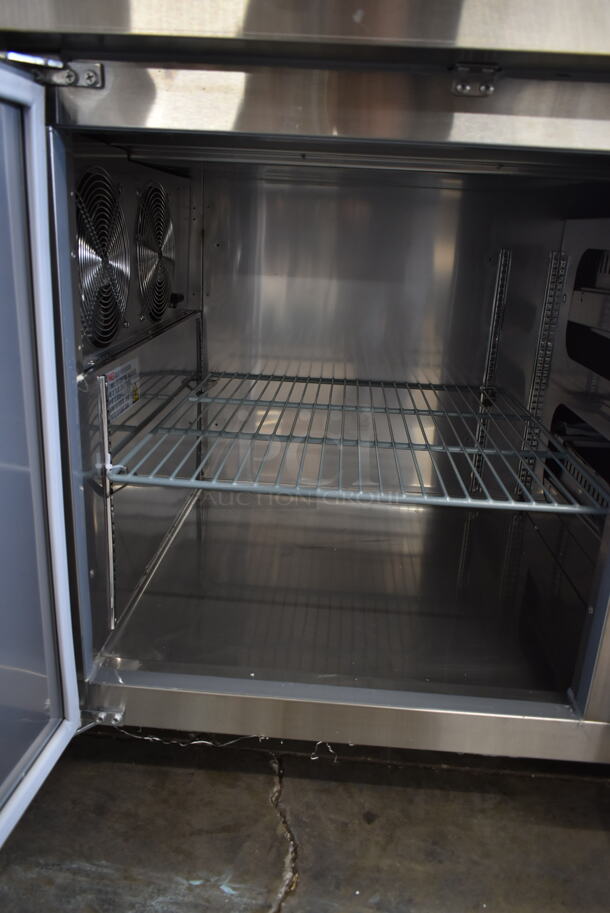BRAND NEW SCRATCH AND DENT! 2023 Avantco 178SSPPT3 Stainless Steel Commercial Pizza Prep Table w/ 2 Doors and 2 Drawers on Commercial Casters. 115 Volts, 1 Phase. Tested and Working! - Image 6 of 9