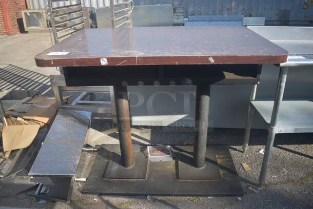 Table With Open Front And Wood Style Top On Two Steel Legs With Base.