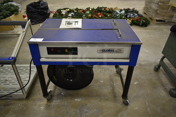 Global Metal Commercial Floor Style Automatic Strapping Machine on Commercial Casters. 115 Volts, 1 Phase. Was In Working Condition When Class Ended. (Main Building)
